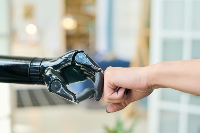 Human and robotic hands in a fist bump, symbolizing collaboration and trust between humans and AI